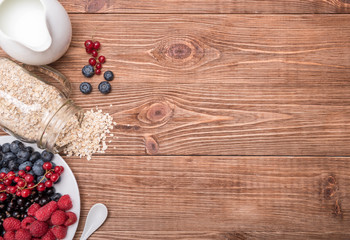 Smoothies with oatmeal ,berries in glass jars on a wooden background.