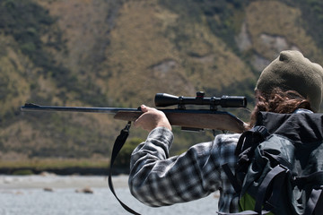 Hunter looking through rifle aim