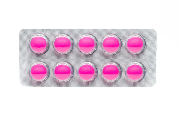 pink tablets pills in blister pack isolated on white background.