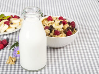 bottle of fresh milk and granola with fruits