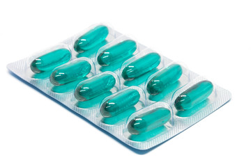 green soft gel capsules pills in blister pack