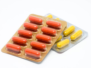 yellow and orange gelatin capsules pills in blister pack