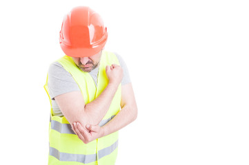 Body injury concept with young foreman holding elbow