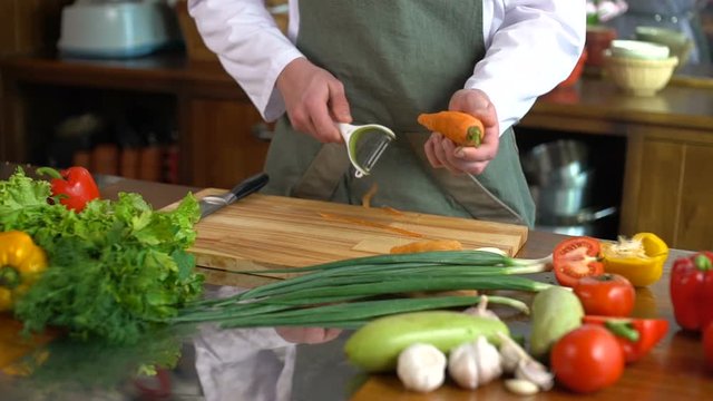 Professional chef cook prepares vegetables for the salad
