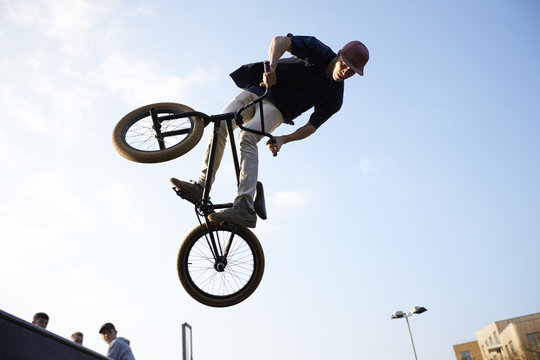 Young man jumping on bmx bicycle