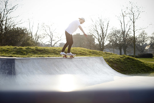 Skateboarder free styling in skatepark