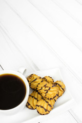 cup of coffee and delicious cakes on a white background