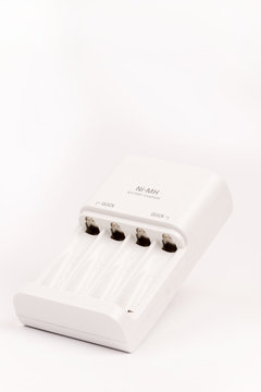 White battery charger over white background with copy space