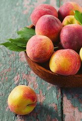 ripe peaches on wooden surface