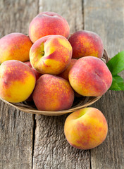 Fototapeta na wymiar ripe peaches on wooden surface