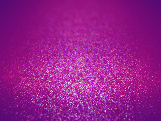 colorful glitter in shades of pink, purple, blue and white on a surface with a spotlight and depth of field effect (3D illustration)