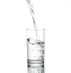 Water poured in a glass transparent white backdrop. © PhotoJuthamat