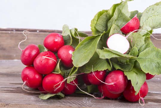 Fresh radishes on old wooden boards