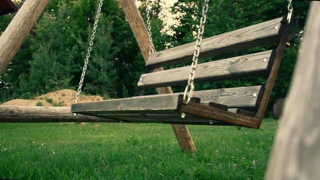 Old swing in the yard with light effect. weirdness