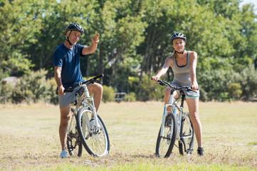 Fototapeta na wymiar Retired couple cycling
