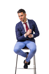 Young man in blue business jacket and jeans isolated