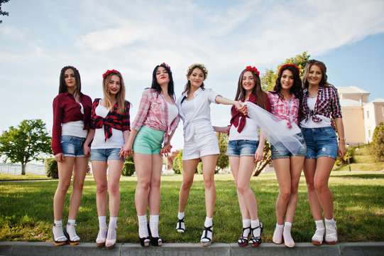 Seven happy and sexy girls on short shorts posed and having fun