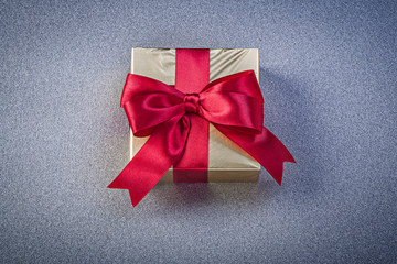 Present box on grey background holidays concept