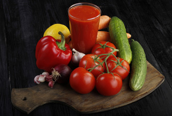 vegetables and tomato juice on wooden background 