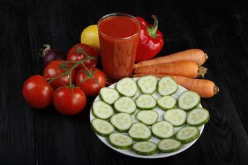vegetables and tomato juice on wooden background