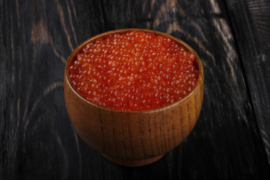 red caviar on wooden background 