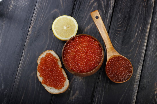 red caviar on wooden background 