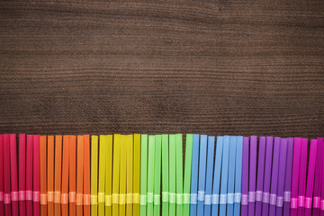 colorful striped bendy cocktail straws on wooden table