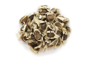 Organic Moringa (Moringa oleifera) seeds isolated on white background. Macro close up. Top view.