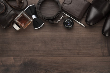 men's accessories in order on the brown wooden table overhead view with copy space