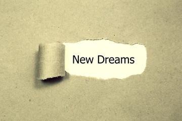 new dreams written under torn orange paper.Business, technology, internet concept