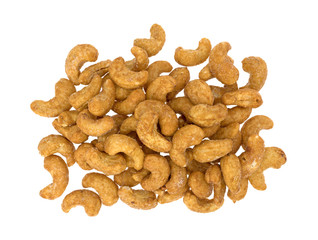 Whole honey roasted cashews on a white background top view.