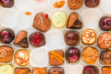 incomplete box of delicious handmade chocolates closeup