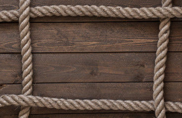 Photo of an old vintage rope on old wooden table. Natural cool light