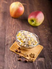 bowl of muesli, apple, nuts, flakes, candied  for a nutritious breakfast with a low glycemic index ensuring plenty of energy for the day. 