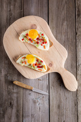 scrambled eggs with bread on cutting board