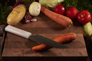 vegetables and knife on board