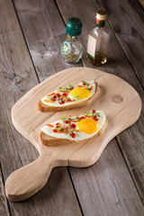 scrambled eggs with bread on cutting board