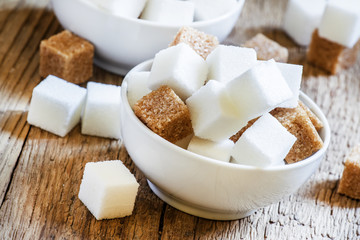 Pieces of white and brown sugar, selective focus
