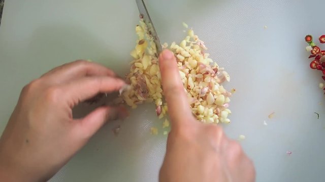chopping garlic in the kitchen prepare food