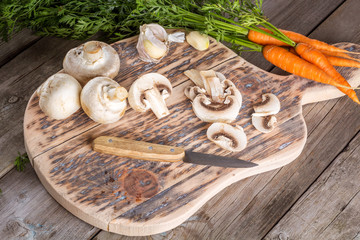 Ingredients for cooking: mushrooms, carrots and garlic