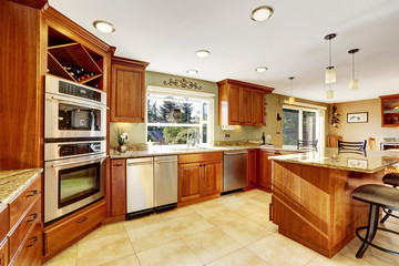 Luxury kitchen with tile floor and stained cabinets