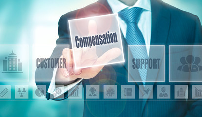 A businessman selecting a Compensation Concept button on a clear screen.