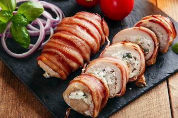 chicken breast stuffed feta cheese and herbs wrapped in bacon - obrazy, fototapety, plakaty