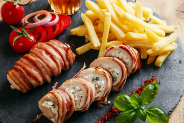 chicken breast stuffed feta cheese and herbs wrapped in bacon - obrazy, fototapety, plakaty