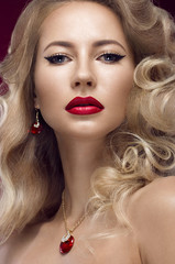 Fototapeta na wymiar Beautiful blonde in a Hollywood manner with curls, red lips. Beauty face.