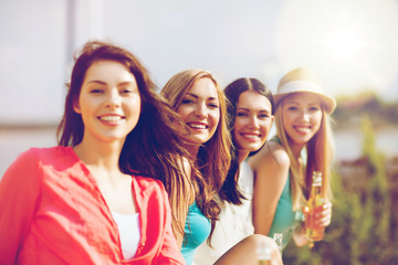 girls with drinks on the beach