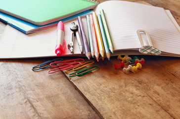 Back to school concept. Writing supplies on wooden desk