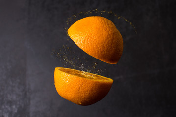 Orange cut are frozen in mid air