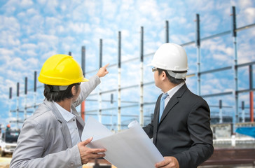 Engineer and foreman looking at blueprints