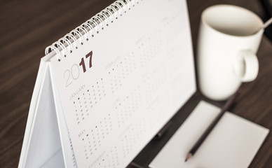 Desktop calendar sitting on desk showing year of 2017.